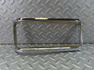 W115 tail light chrome frame left used OEM