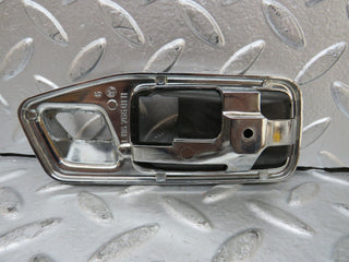 W123 chrome frame door opener front left used OEM